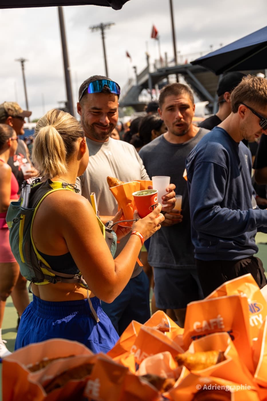 Runners collecting coffee and pastries from a food stand